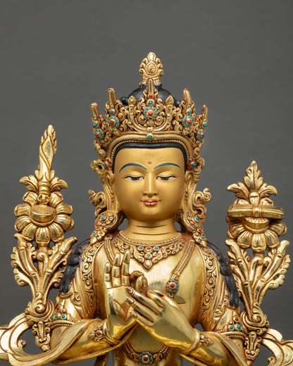 Close up of Manjushree Statue with gold painted face semi precious stones and wisdom expression