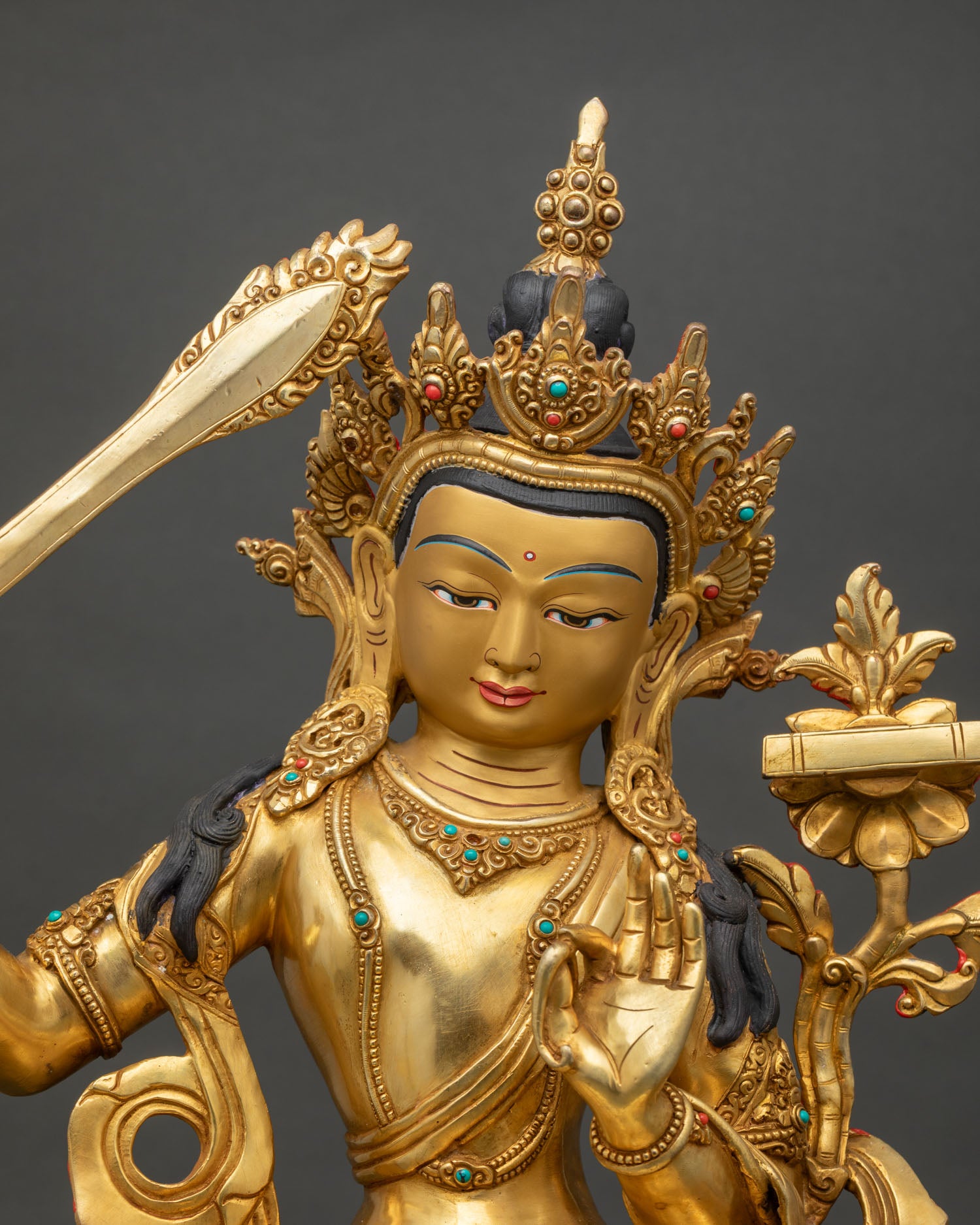 Close up of Manjushri Bodhisattva face showing semi precious stones and fine Newari craftsmanship details