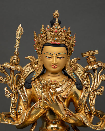Close-up of Manjushri Bodhisattva face with five-jeweled crown, semi-precious stones, and detailed Himalayan Buddhist craftsmanship