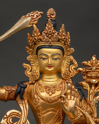 Close up of Manjushri Bodhisattva statue with gold painted face and Prajnaparamita Sutra