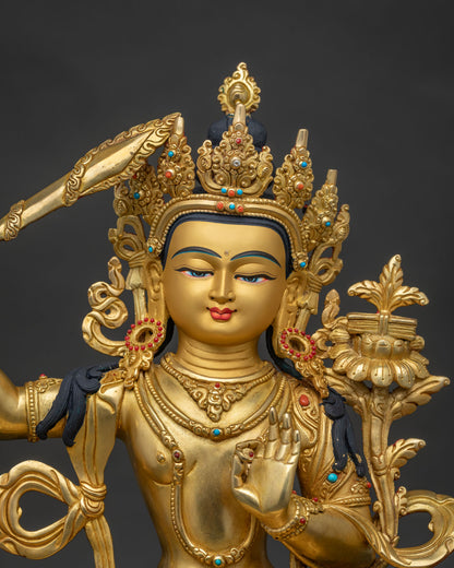 Close up of Manjushri Buddhist statue with gold painted face and intricate details