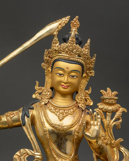 Close up of Manjushri face with gold painted finish and serene wisdom expression details.