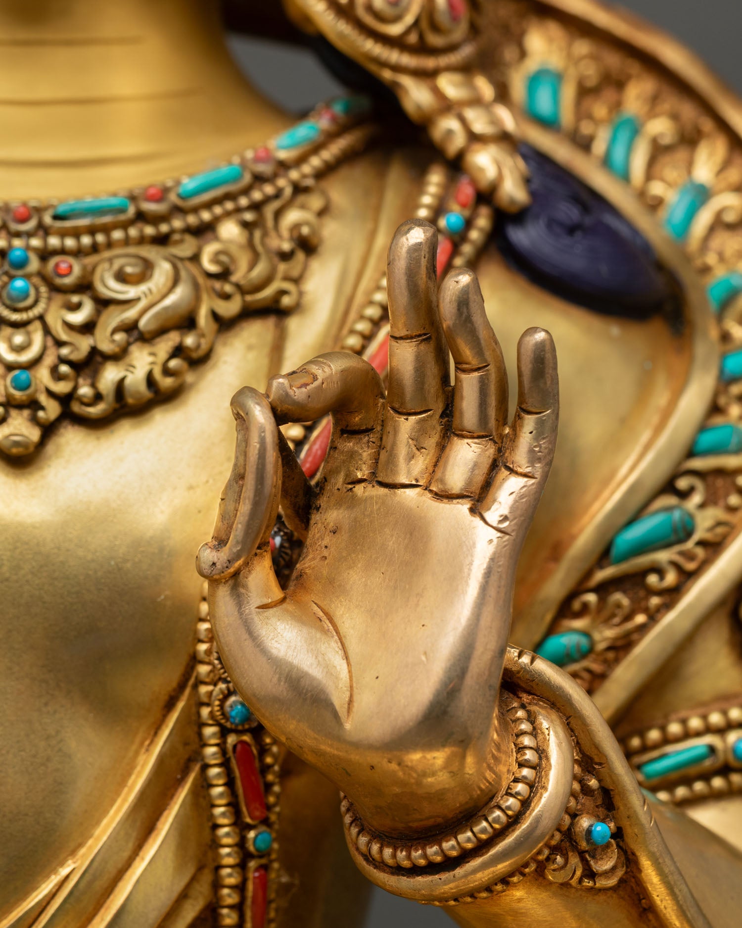 Close-up of Manjushri hand in Vitarka Mudra symbolizing wisdom and spiritual teaching