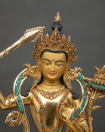 Close up of Manjushri statue holding wisdom sword and utpala flower, handcrafted in Nepal