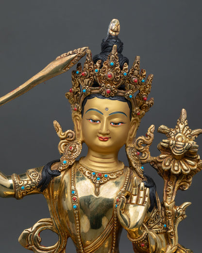 Close-up of Manjushri statue showing detailed gold-gilded craftsmanship and sacred ornaments