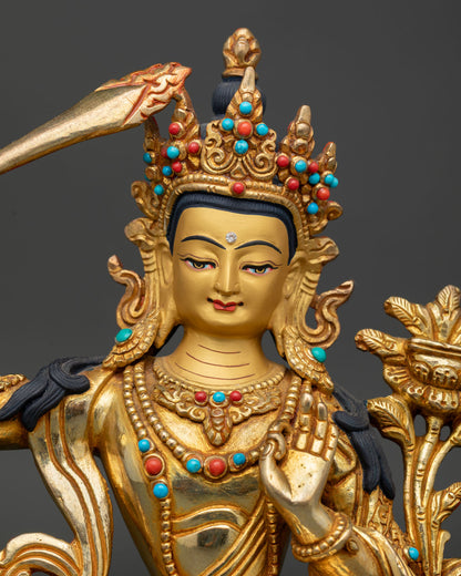 Close Up of Manjushri Statue with Gold Painted Face and Intricate Himalayan Buddhist Craftsmanship