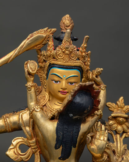 Close up of Manjushri with consort gold painted faces and Prajnaparamita scripture detail.
