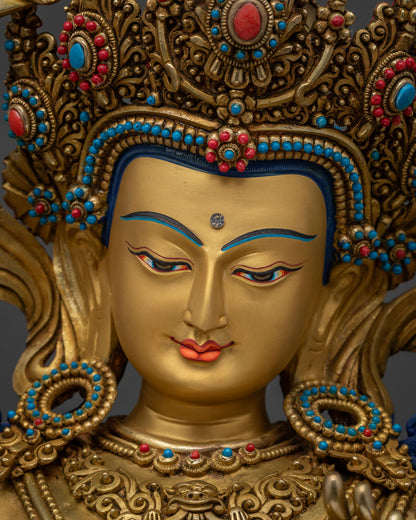 Close-up of Manjushri's gold-painted serene face, handmade Nepal statue