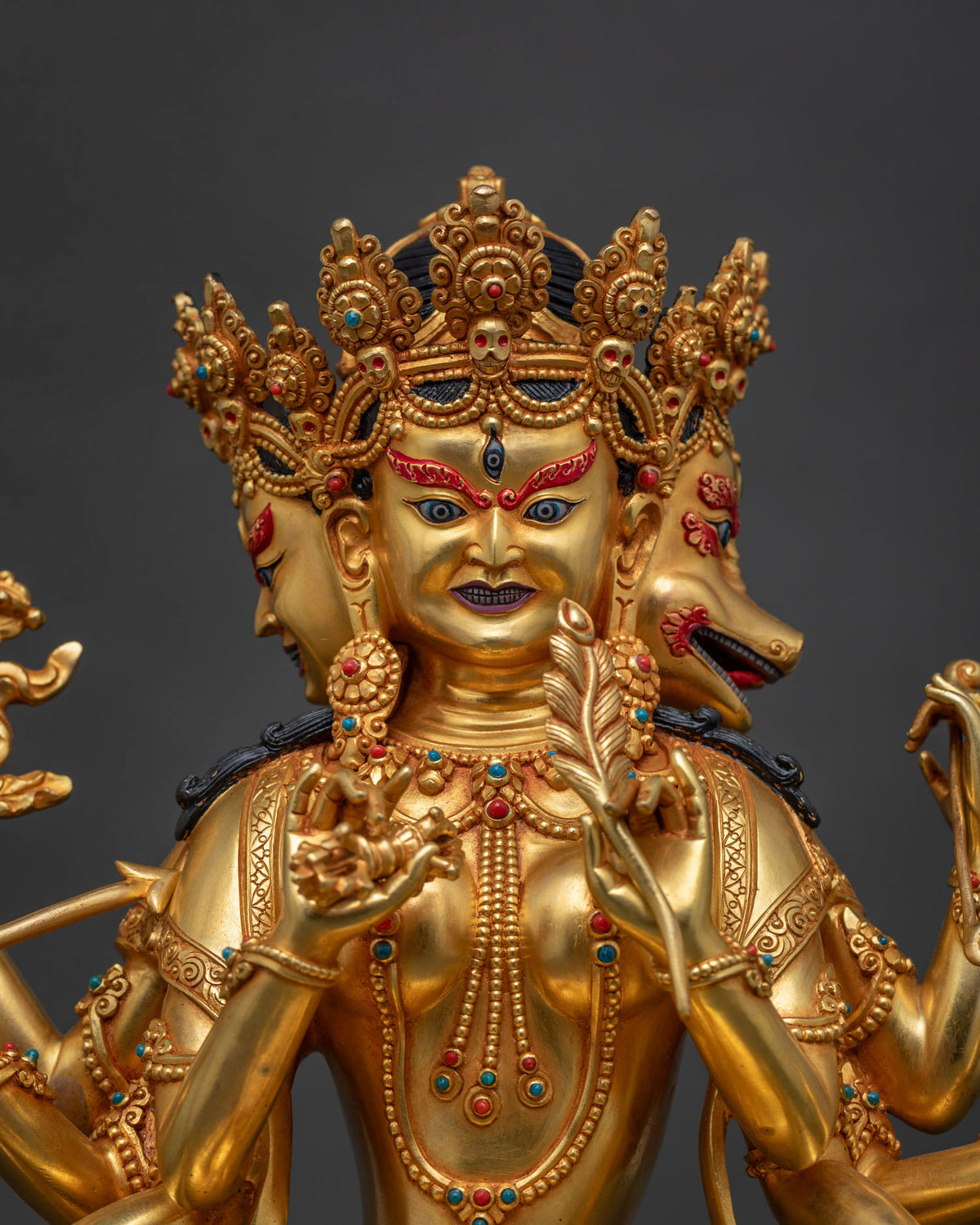 Close-up of Marichi statue Kyoto, three wrathful heads, gold fire-gilded Nepalese sculpture