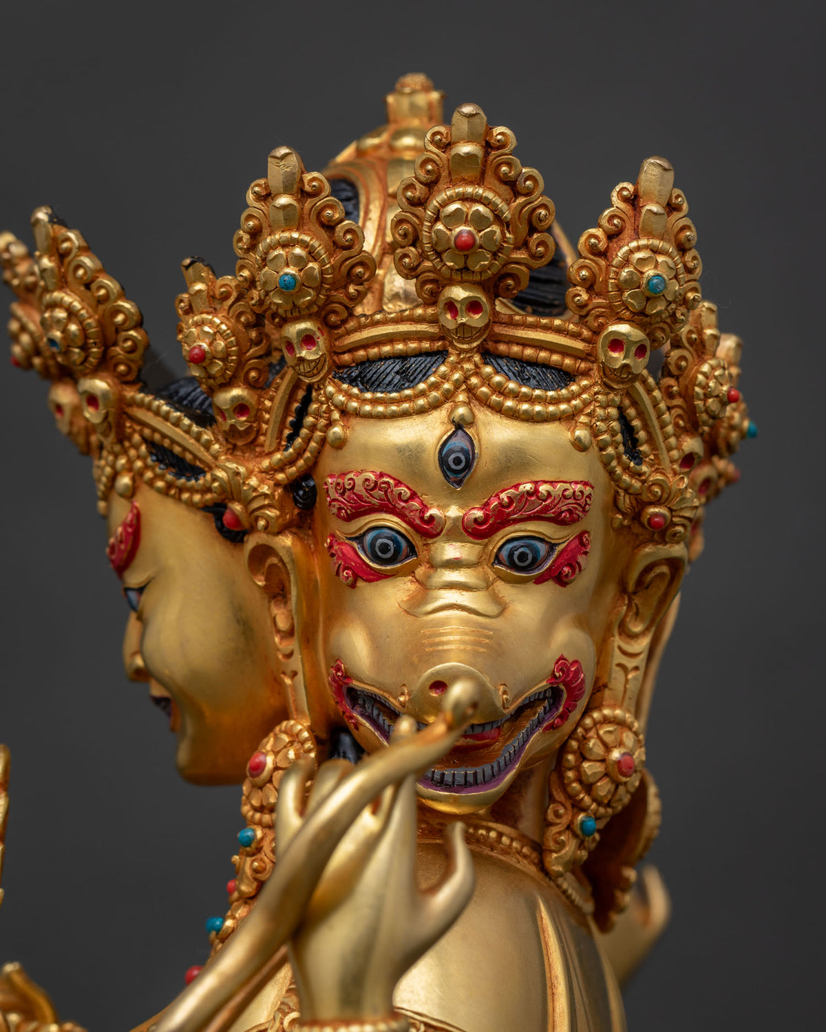Close-up of Marichi's face, sow head and wrathful expression, gold fire-gilded copper