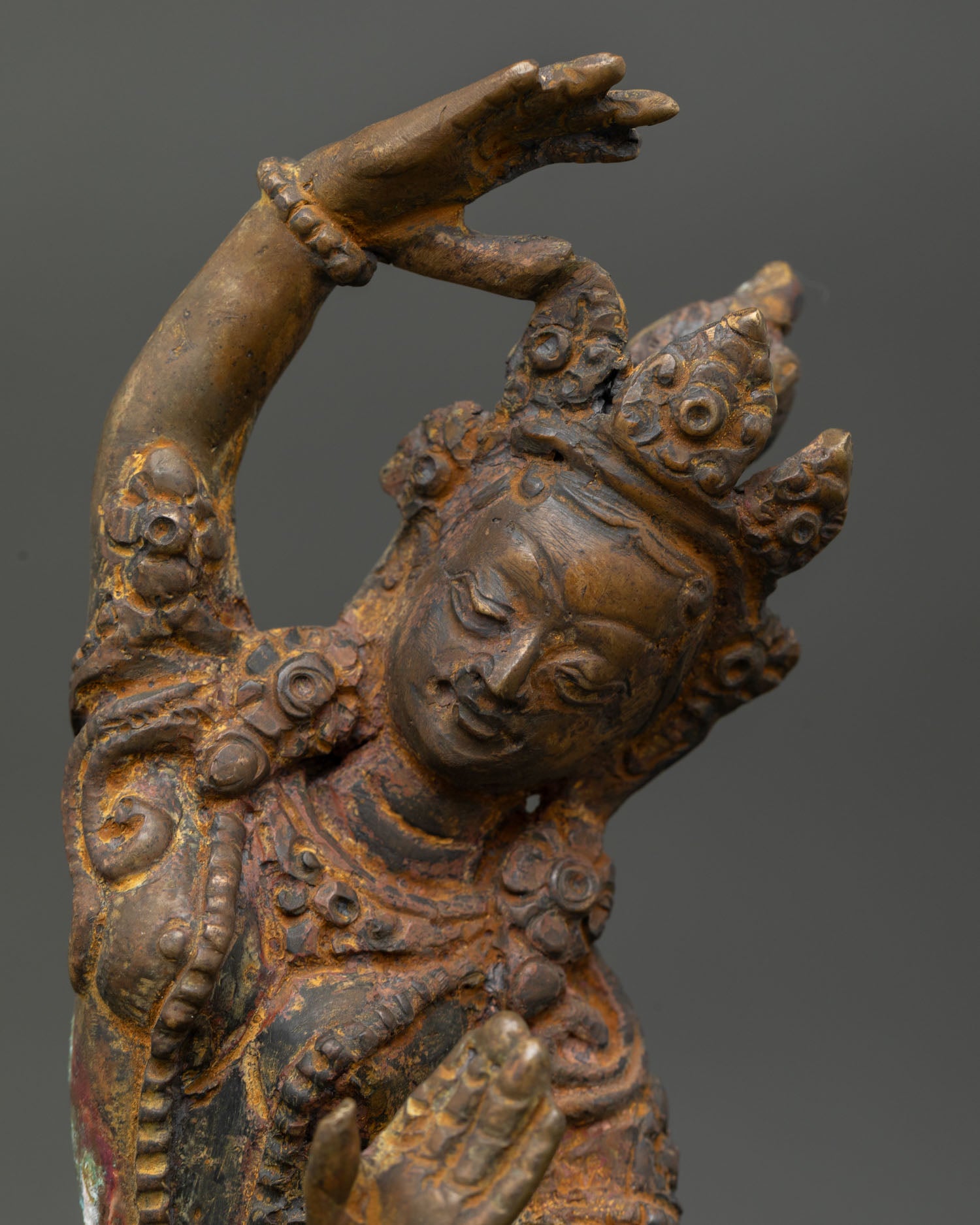 Close Up of Maya Devi Statue with Layered Necklaces and Antique Finish.
