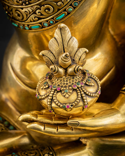 Close-up of Medicine Buddha left hand cradling healing bowl, gilded copper statue handcrafted in Nepal