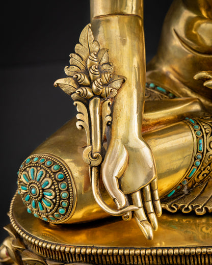 Close-up of Medicine Buddha right hand holding myrobalan plant with turquoise lotus detail, Nepal statue