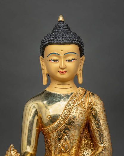 Close-up of Medicine Buddha Statue featuring a serene gold-painted face, finely detailed Buddhist features