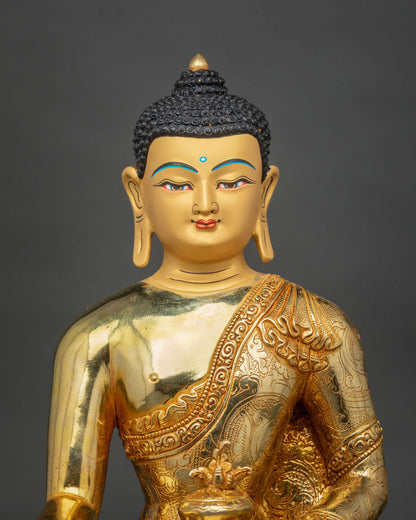 Close-up of Medicine Buddha Statue highlighting the gold-painted face, intricate robe details, and traditional Newari craftsmanship.