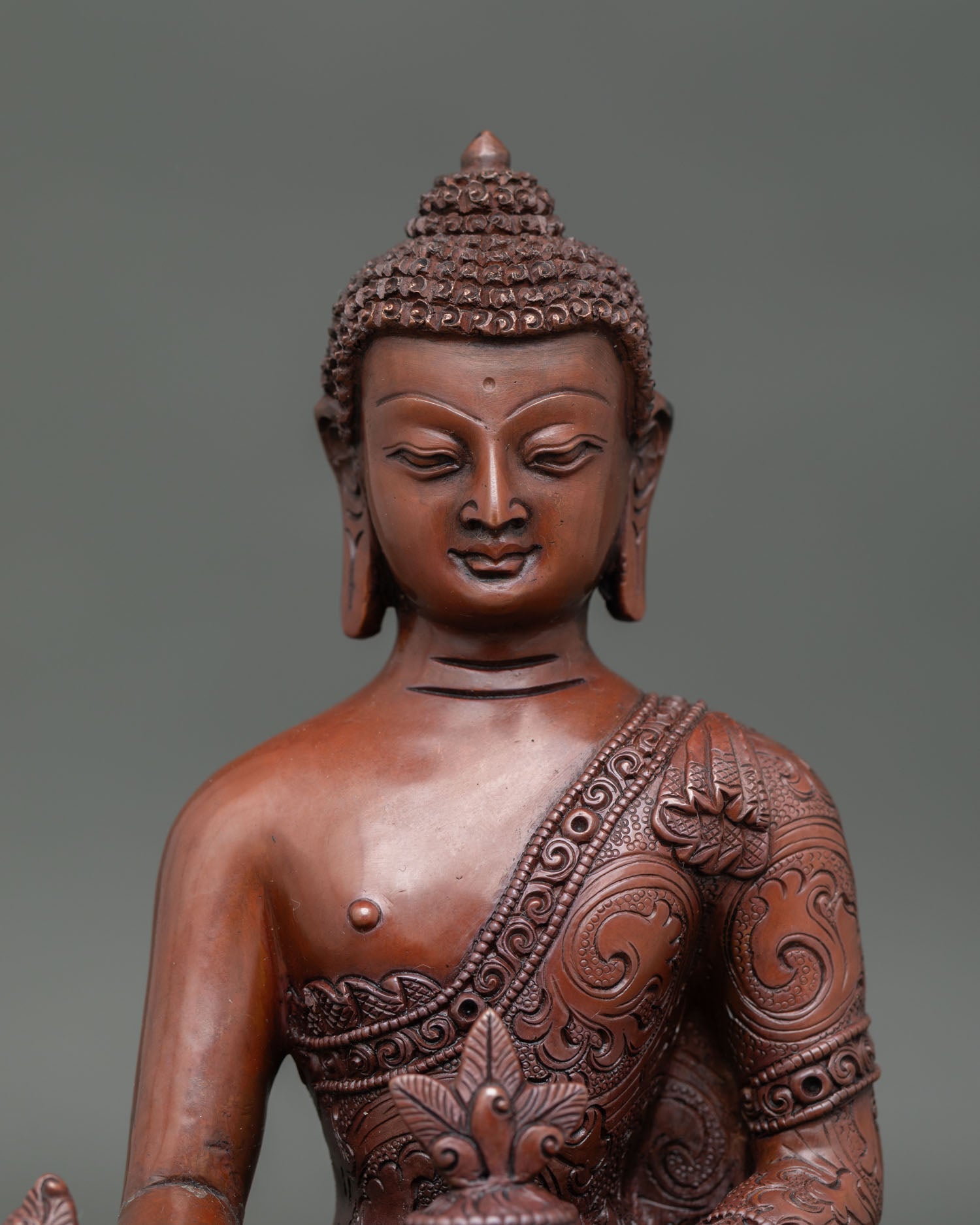 close-up of medicine buddha statue showing oxidized copper craftsmanship