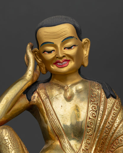 Close up of Milarepa face with gold painted finish and serene enlightened expression details.