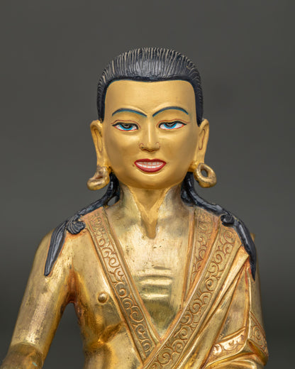 Close-up of Milarepa statue face showing hand-painted mineral pigment eyes, flowing black hair, and fine Himalayan craftsmanship details