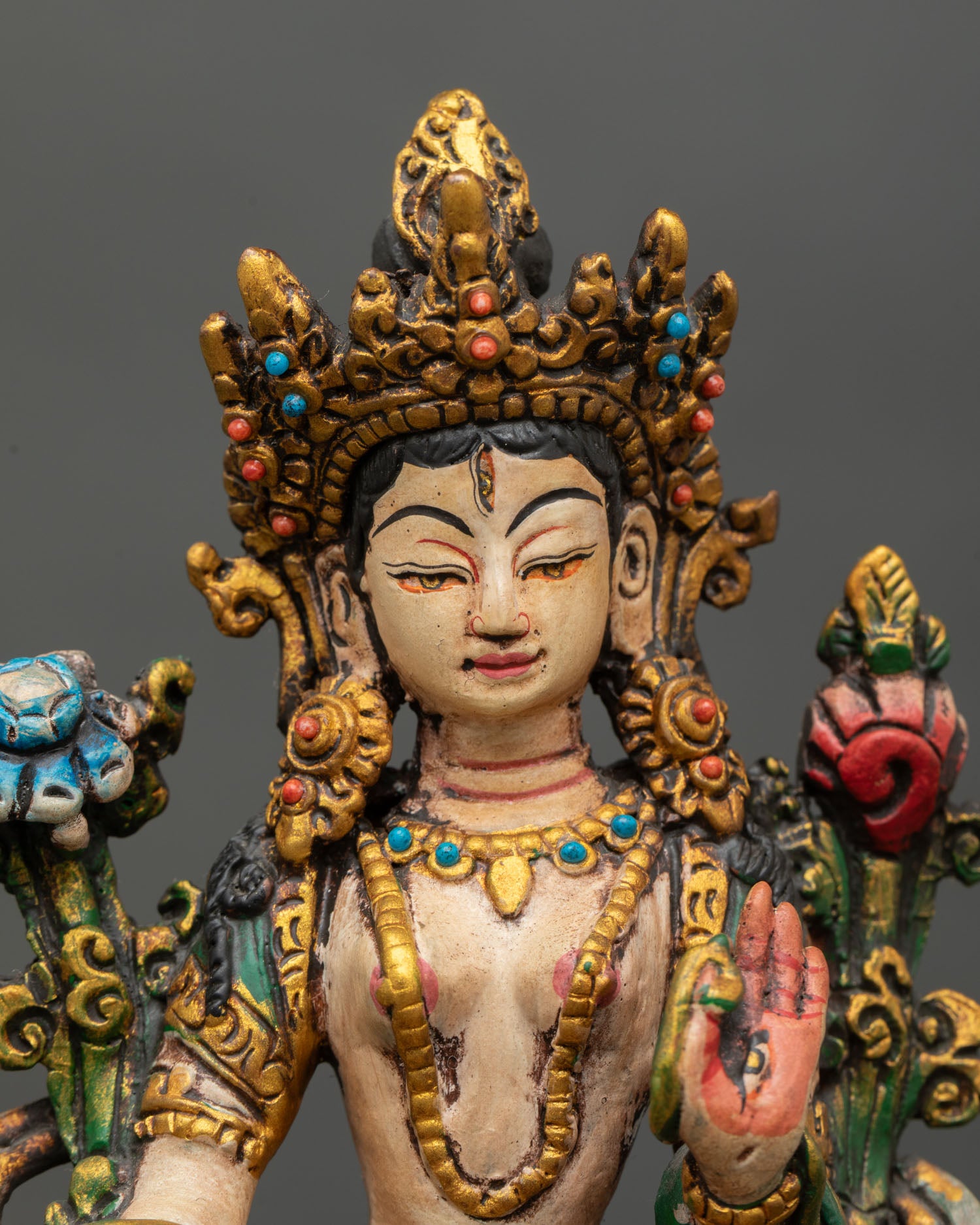 close up of mini white tara statue with acrylic painted buddhist art details