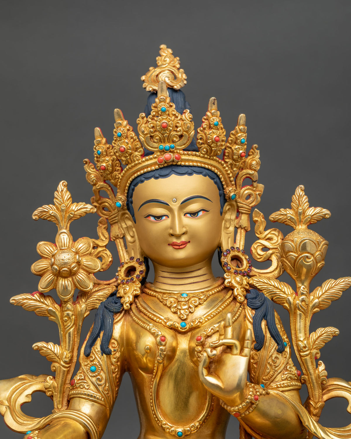 Close up of Mother Green Tara statue with 24K gold gilding, jeweled crown and floral details
