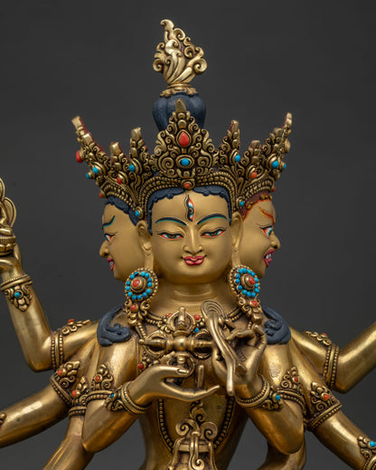 Close up of Namgyalma Buddhist deity statue with three faces and gold painted details