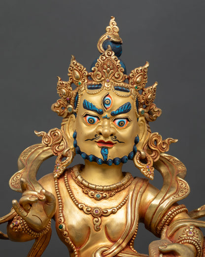Close up of Namtoshe statue with flaming halo gold painted face and semi precious stone detailing