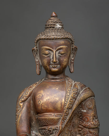 Close-up of Nepalese Shakyamuni Buddha statue featuring intricate carvings and an antique oxidized copper finish.