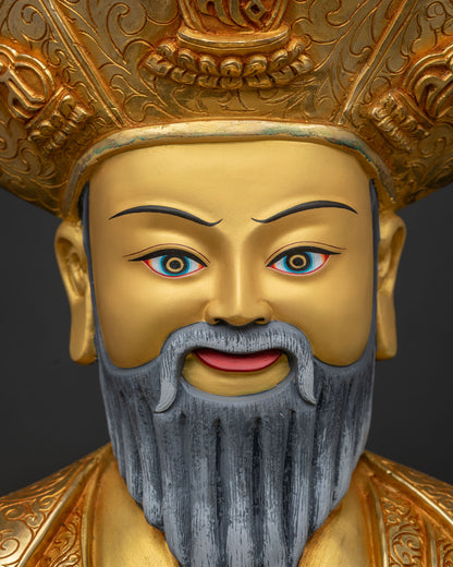 Close-up of Ngawang Namgyal's serene gold-painted face and crested lama hat