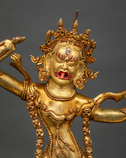 Close-up of one-eyed Ekajati statue face with extended red tongue and gold paint