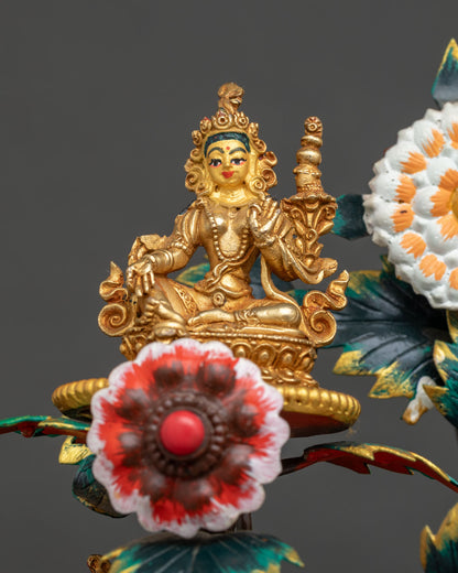 Close-up of one miniature gold gilded Tara beside a flower in the 21 Tara Statue Set