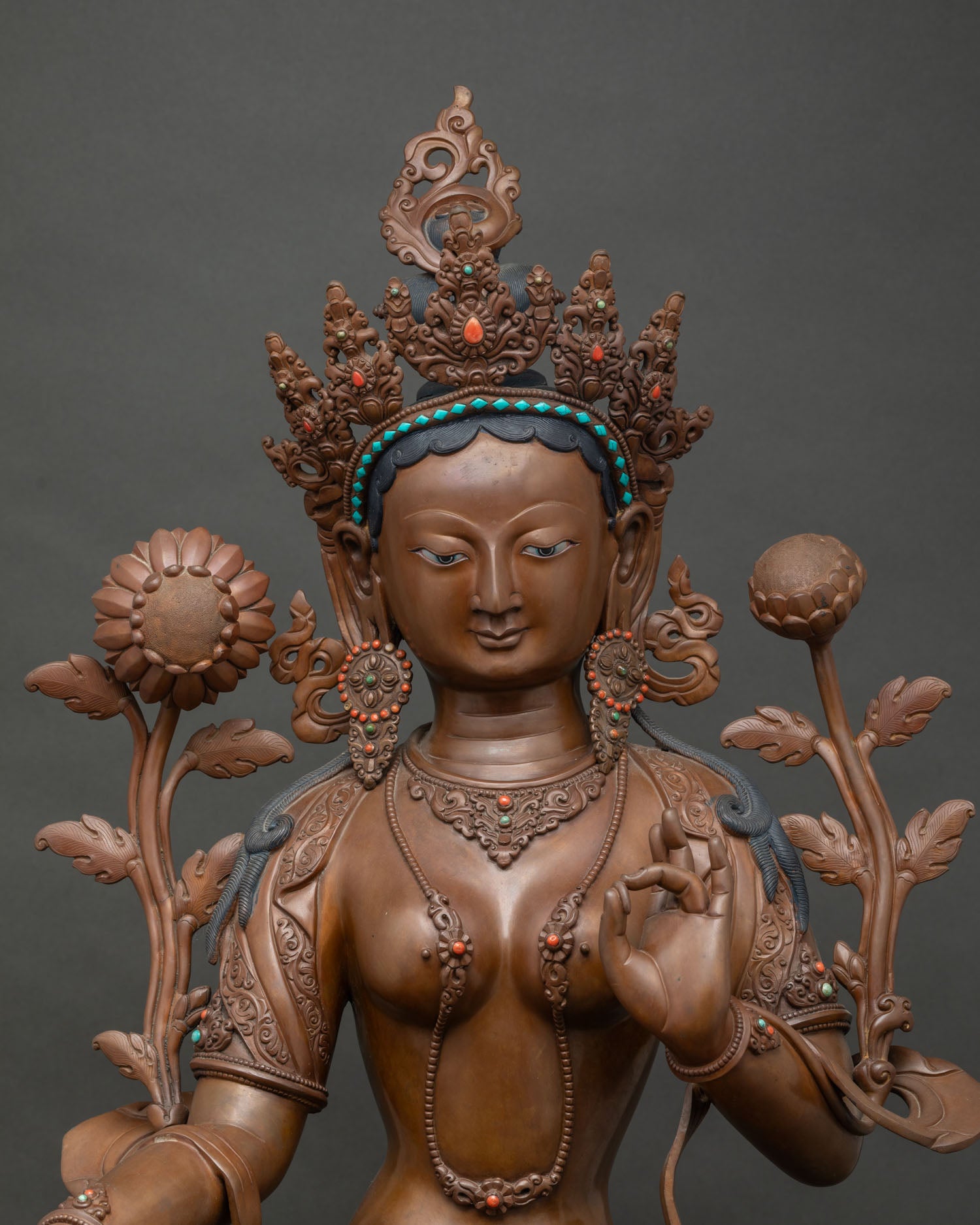 Close-up of oxidized copper Green Tara statue showing crown and jewelry detail