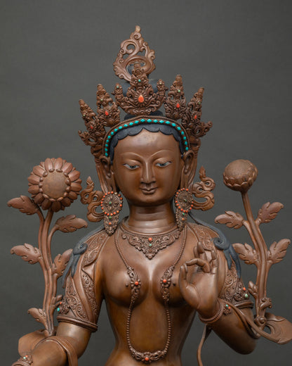 Close-up of oxidized copper Green Tara statue showing crown and jewelry detail