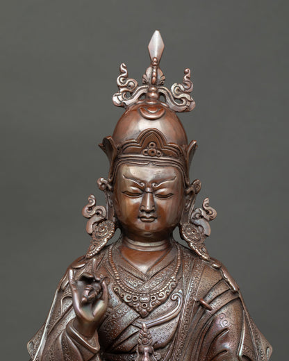 Close up of oxidized copper Tsokye Dorje statue holding a vajra and skull cup