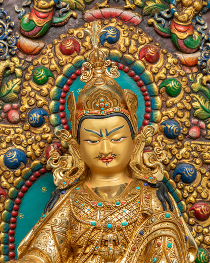 Close-up of Padmasambhava's gold-painted face and crown on Guru Rinpoche statue