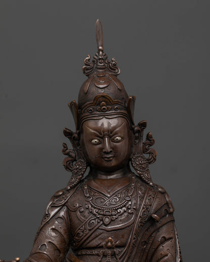 Close up of Padmasambhava statue showing semi wrathful face and sacred ornaments