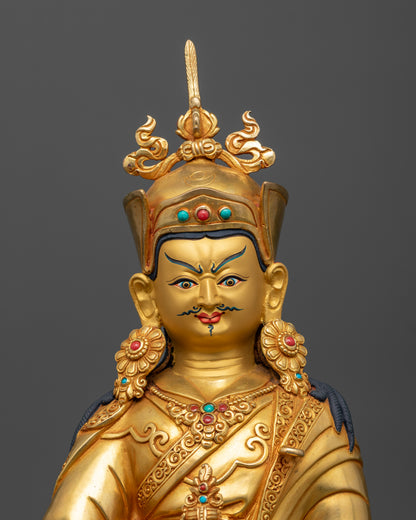 Close up of Padmasambhava Statue, showing serene gold painted face and Himalayan craftsmanship