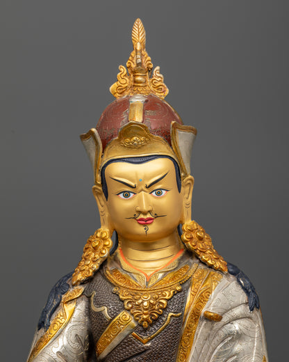 Close up of Padmasambhava Statue with gold painted face and intricate floral robe carvings
