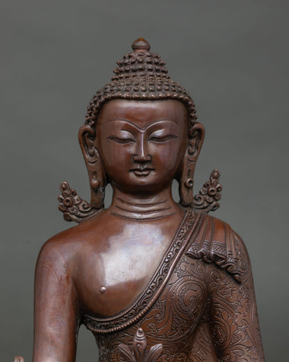 Close-up of peaceful face and ushnisha on oxidized copper Medicine Buddha statue