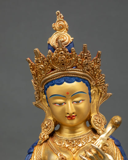 Close-up of Saraswati statue showing intricate gold gilding and jewelry details