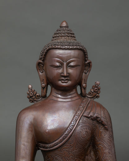 Close-up of serene face and ushnisha on oxidized copper Buddha statue