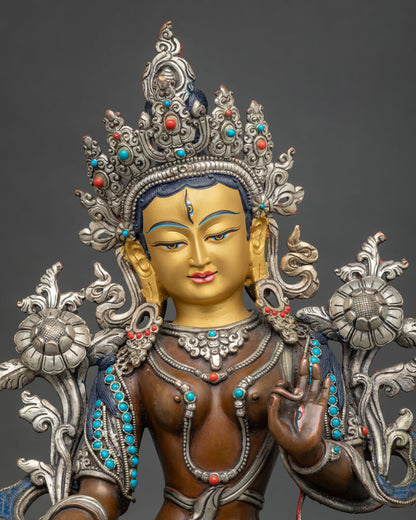 Close up of Seven-Eyed White Tara Statue with silver-plated crown, turquoise and coral jewelry