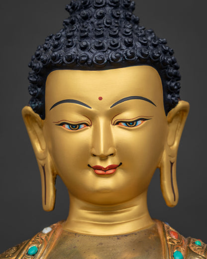 Close-up of Shakyamuni Buddha face, gold-gilded features with hand-painted eyes