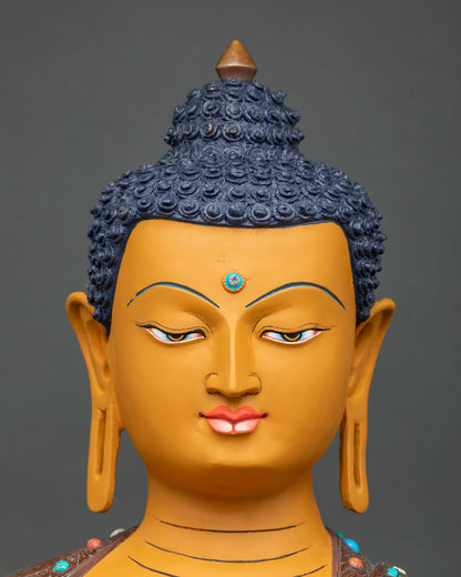 Close-up of Shakyamuni Buddha face with serene expression and vibrant acrylic-painted finish