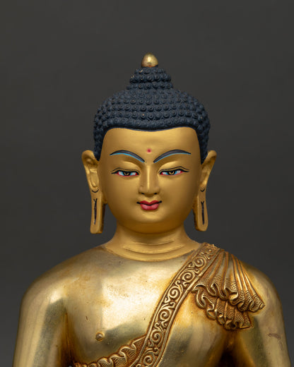 Close up of Shakyamuni Buddha gold painted face serene expression handcrafted Newari art