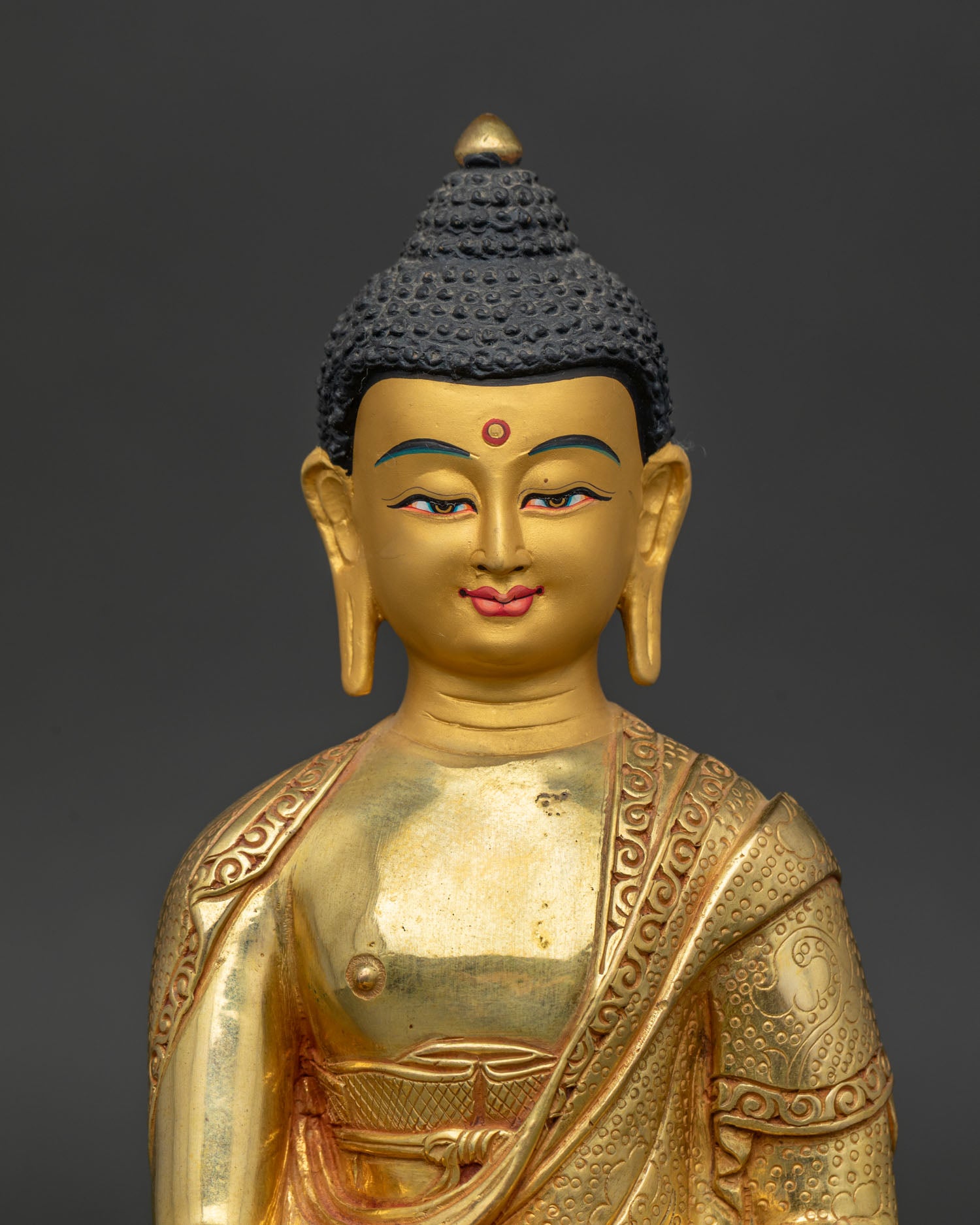 Close-Up of Shakyamuni Buddha Gold Painted Face with Bhumisparsha Mudra.