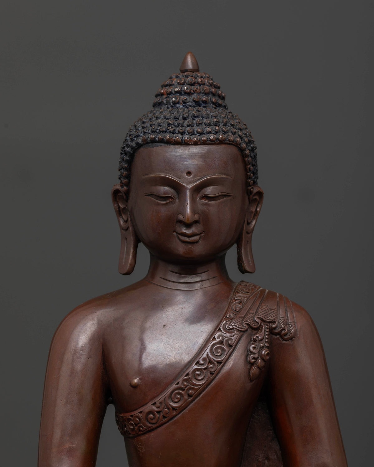 Close up of Shakyamuni Buddha showing peaceful face and detailed Buddhist sculpture