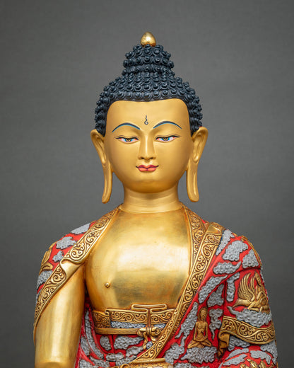 Close-up of Shakyamuni Buddha statue gold face with deep-blue eyes and hand-painted life story robe