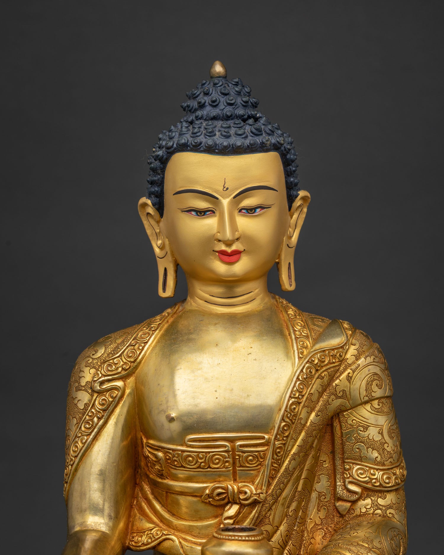 Close-up of Shakyamuni Buddha statue, gold-gilded copper sculpture on lotus pedestal