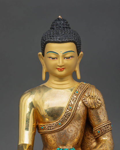 Close up of Shakyamuni Buddha statue serene face hand painted gold turquoise coral details
