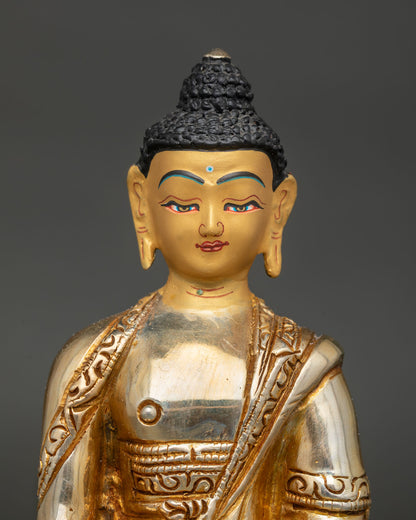 Close-up of Shakyamuni Buddha Statue showing earth-touching mudra and gold-painted face